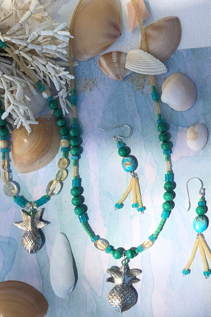 This necklace Sunny Coast inspired one off piece was made in our Noosa Studio,  There is a Thai silver pineapple as the central focus, the beads are the green, gold and turquoise of the area.