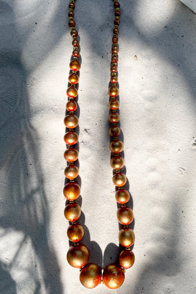  A Long necklace with hand painted beads in graduating sizes