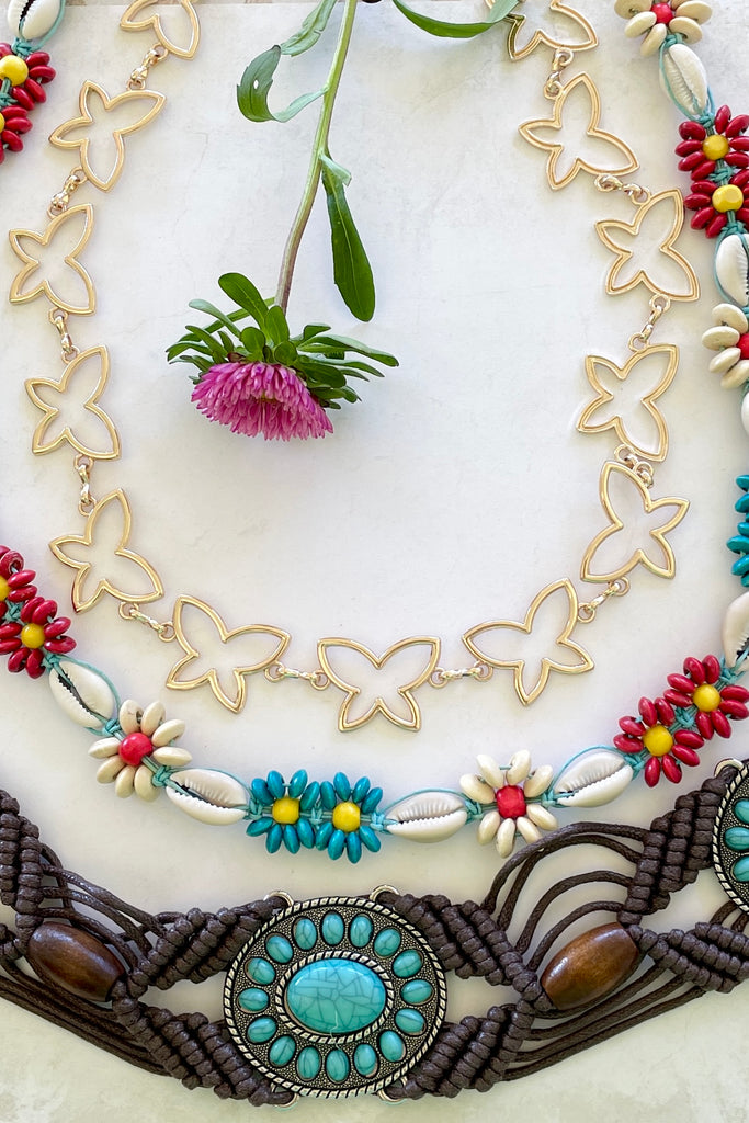 a macrame knotted and beaded belt embellished with turquoise beaded conch detail. 