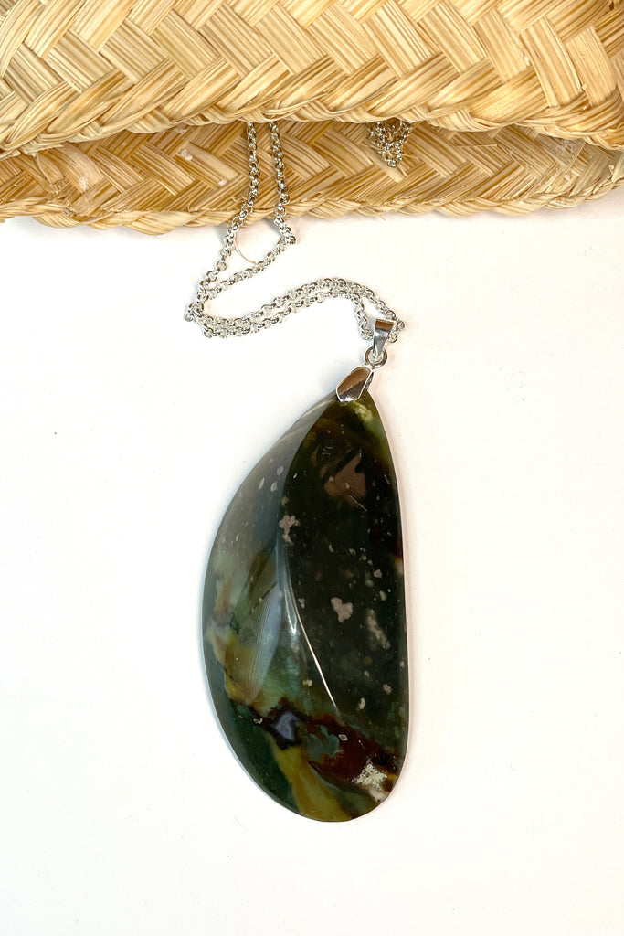 This pendant is a lovely piece of deep grey green Agate stone that has been skillfully cut into a pleasing swirl shape then polished, by ROAM Ladies Lapidary Collective in Sakaraha, Madagascar.