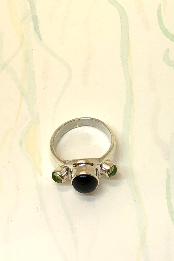 Echo Ring Onyx and Peridot is a powerful silver ring with black onyx cabachon set in 925 silver with Peridot side stones.