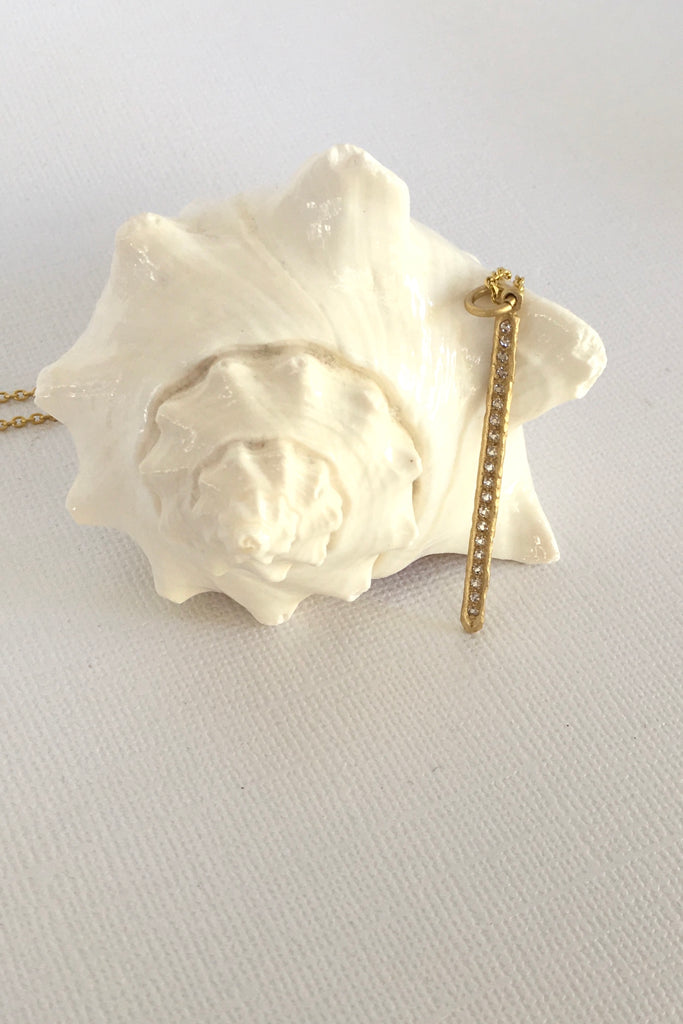 Made in gold vermeil and tiny sparkling white topaz gemstones, the finish is quiet and naturalistic, the surface is matte. 