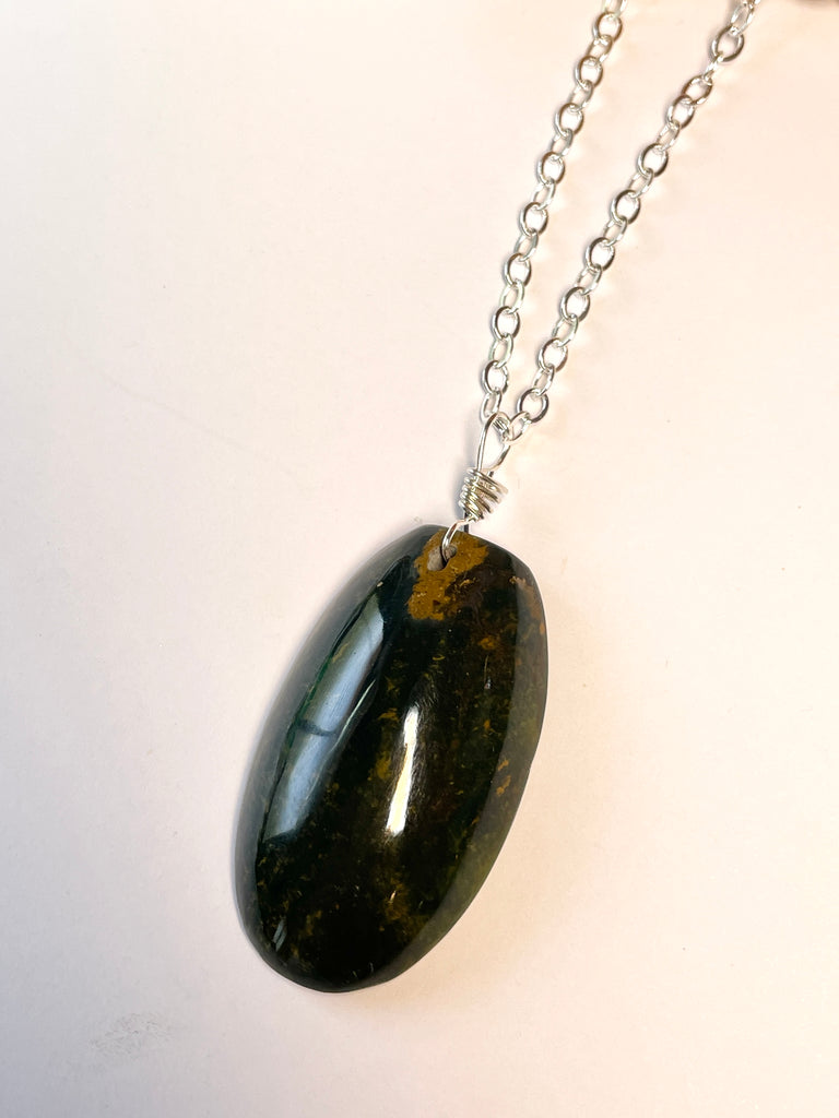 This pendant is a lovely piece of dark grey green Agate stone that has been skillfully cut into a pleasing oval shape then polished, by ROAM Ladies Lapidary Collective in Sakaraha, Madagascar. 