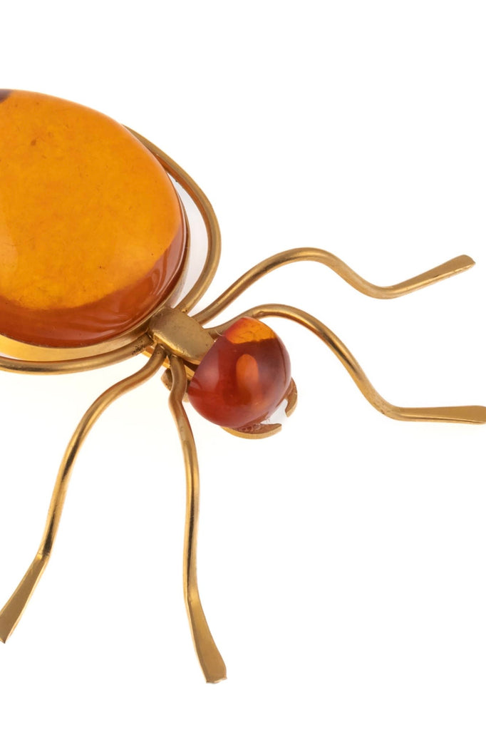 Features the form of a six legged bug with the head and body set with cabochons of natural Baltic honey amber. Marked on underside. A super quirky insect brooch