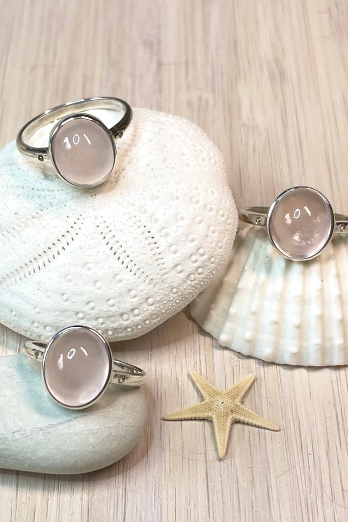 A beautiful feminine, pale luminous pink Rose Quartz  gemstone ring, this darling and dainty little ring has a tiny genuine diamond set into the band on each side of the centre stone.