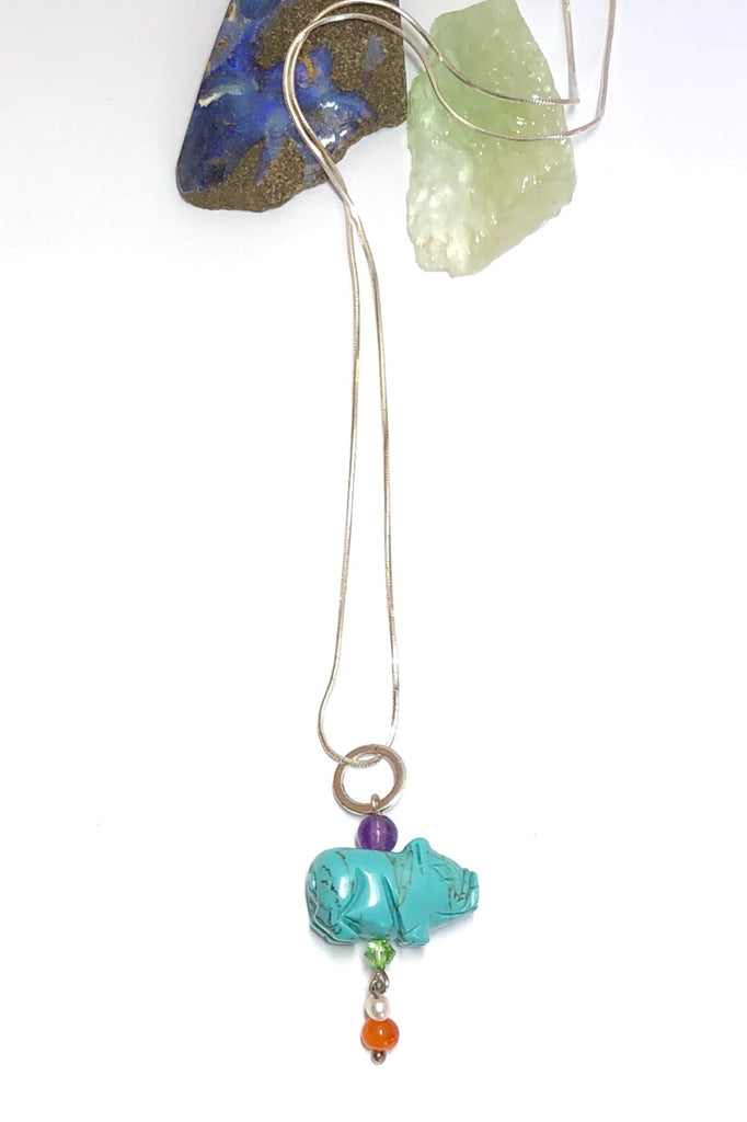 Pendant tiny Howlite Pig on Silver Chain features pig shape turquoise dyed Howlite gemstone with an amethyst top bead, Carnelian and pearl bead with a green crystal bead.