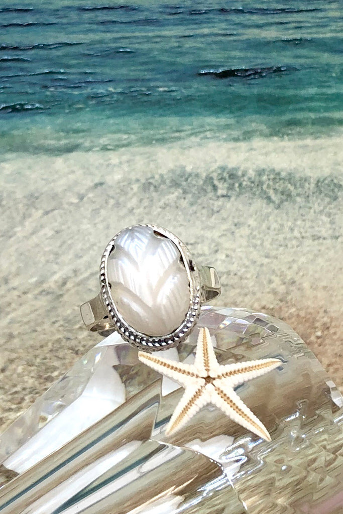 The Echo Ring Moonstone Carving is a handmade moonstone cabachon ring featuring set in silver with a hand carved leaf design.