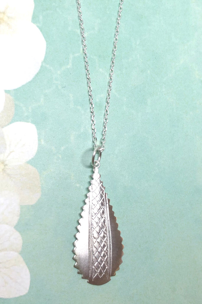 Silver pendant designed in African chic modern style.