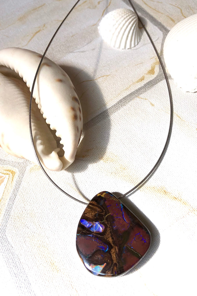  this intriguing piece of Boulder Opal was mined, cut and polished in Queensland. The flashes of colour give one a glimpse into the past. 