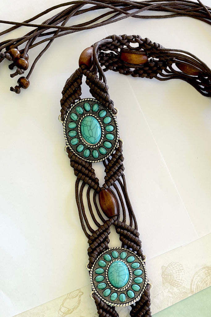 a macrame knotted and beaded belt embellished with turquoise beaded conch detail. 
