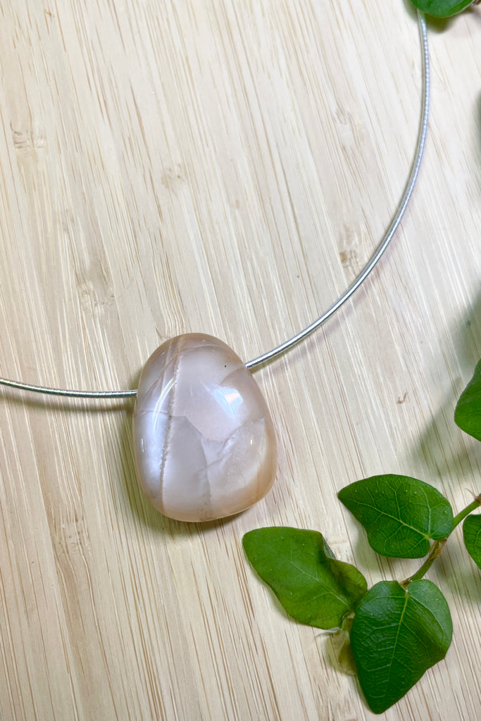 The Pendant is a really lovely luminescent peach moonstone, it hangs from a 925 silver Omega chain. 