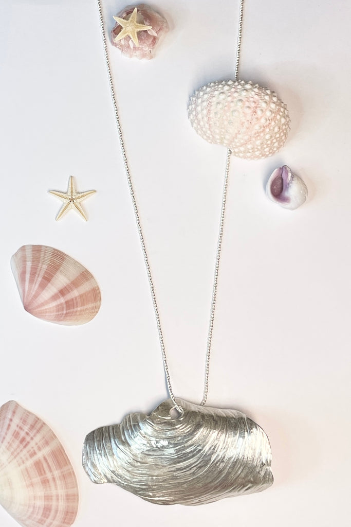 The centre piece is solid silver, it is a cast from a shell found on the Noosa North Shore. The necklace is just so special, the design is original as it is cast directly from the shell. The back of the piece is beautifully inscribed with a pattern of bubbles and waves.