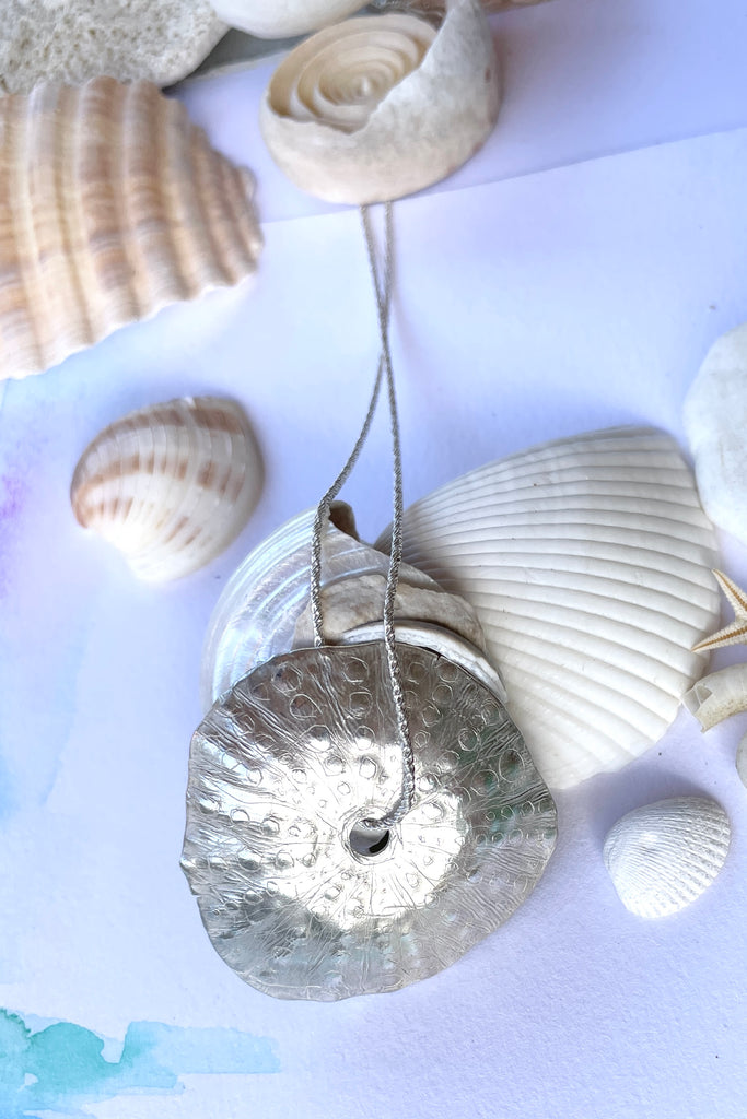 The centre piece is in heavy solid  silver, it is cast directly from a sea urchin shell. 