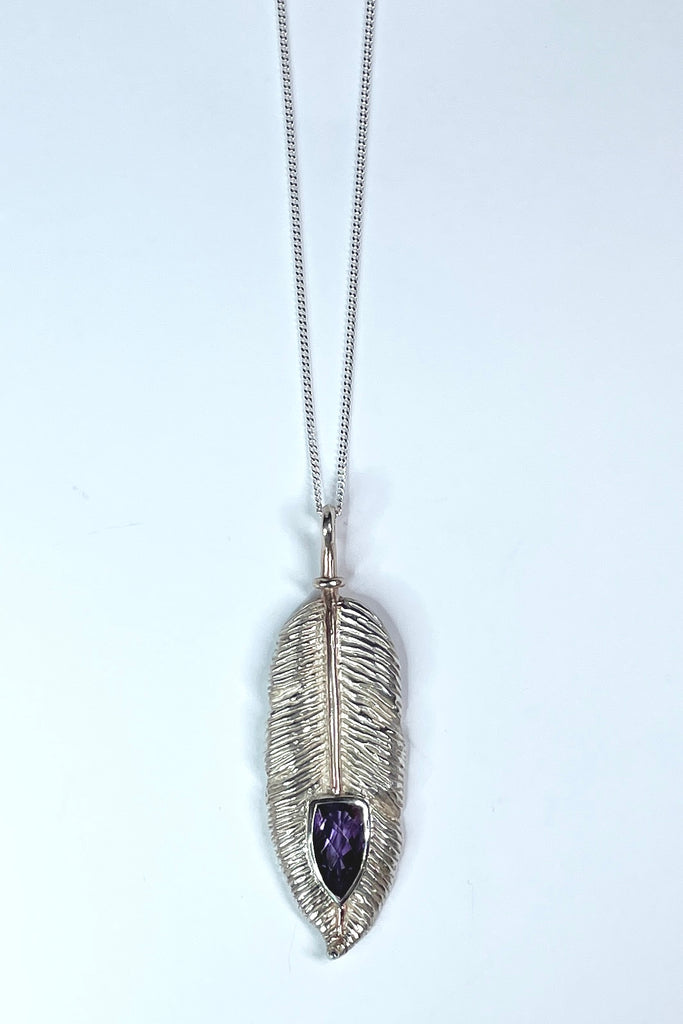 silver feather pendant was designed exclusively for Mombasa Rose, it has a sparkling natural Amethyst set into the piece, it hangs from a good 925 silver chain. 