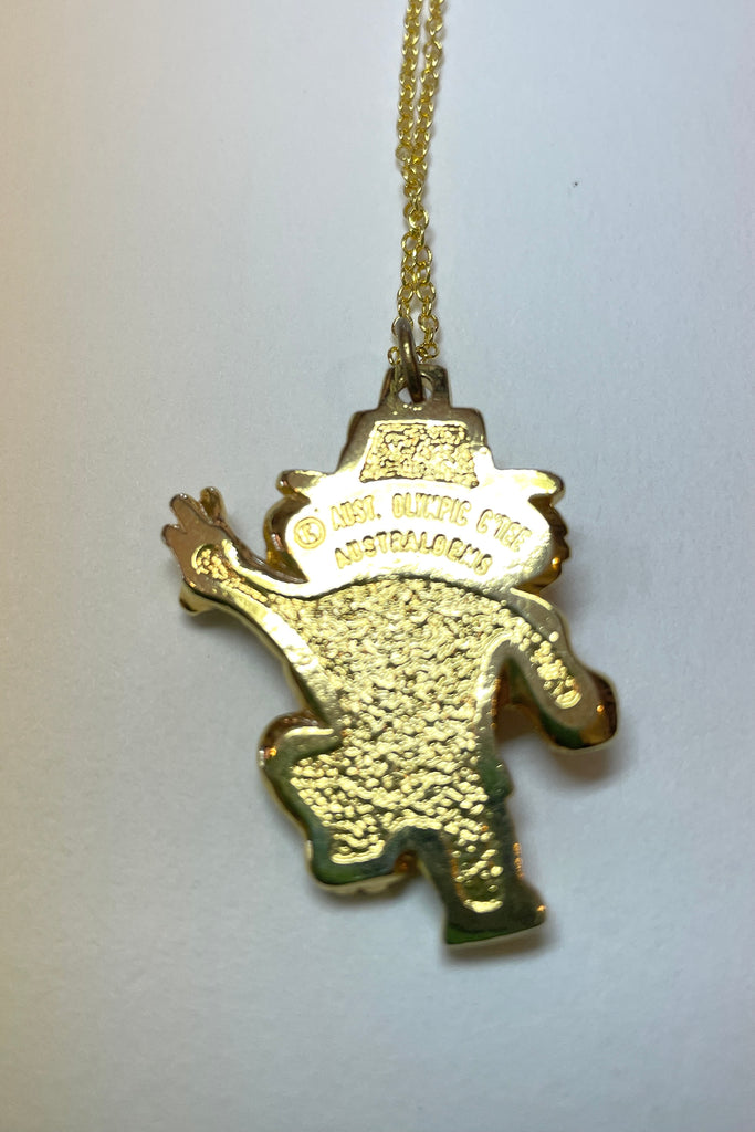 A very quirky pendant, a Koala with a shot putt, there is a conceptual opal on the head. The opal is made from genuine opal chips held in resin. On the back inscribed with Aust. Olympic C'tee. Australian Olympic Souvenir.