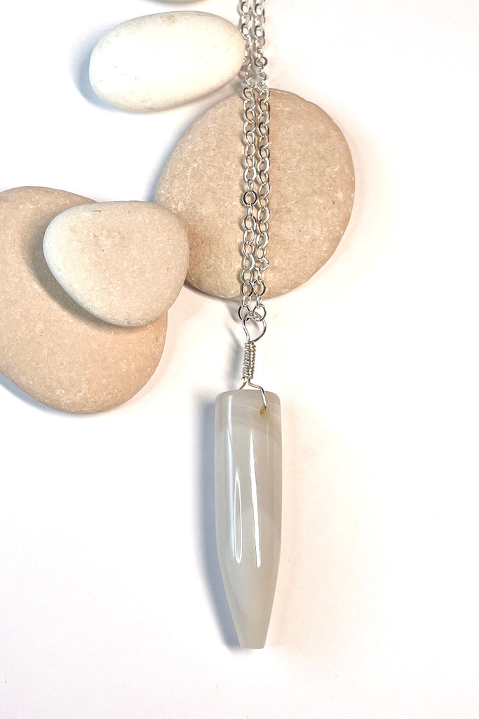 This pendant is a lovely piece of slightly transparent white Agate stone that has been cut and polished by ROAM Ladies Lapidary Collective in Sakaraha, Madagascar. 