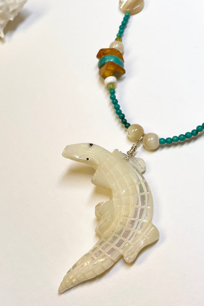 This necklace is a one off piece, the stones are all natural semi precious gems and mother of pearl shell. The crocodile is hand carved from a mother of pearl sea shell