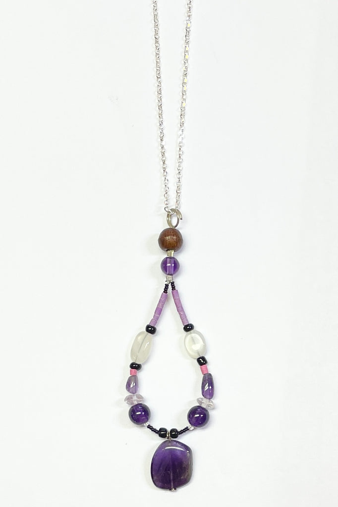 Handmade talisman pendant, featuring a mix of natural material