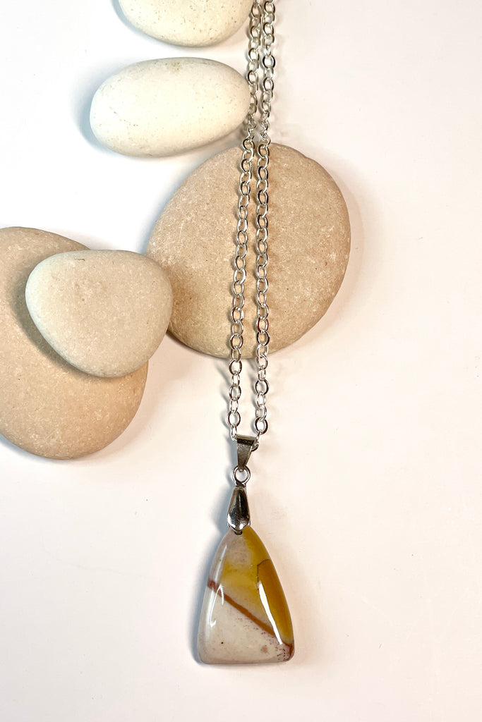 This little triangular pendant is a pretty piece Agate stone that has been cut and polished by ROAM Ladies Lapidary Collective in Sakaraha, Madagascar. 