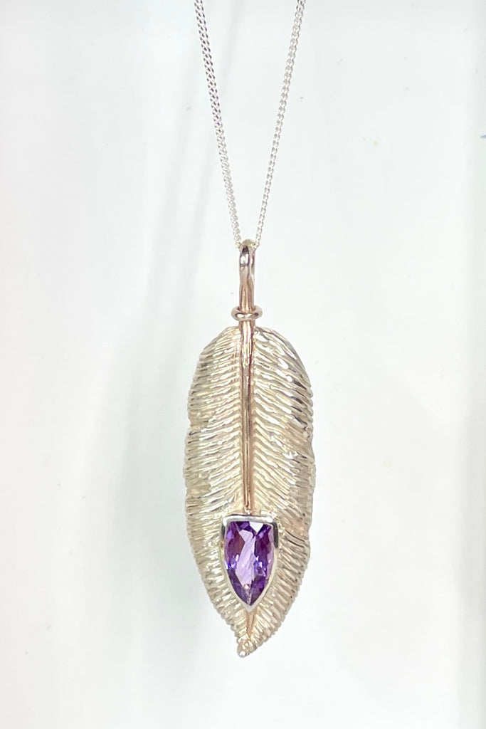 silver feather pendant was designed exclusively for Mombasa Rose, it has a sparkling natural Amethyst set into the piece, it hangs from a good 925 silver chain. 