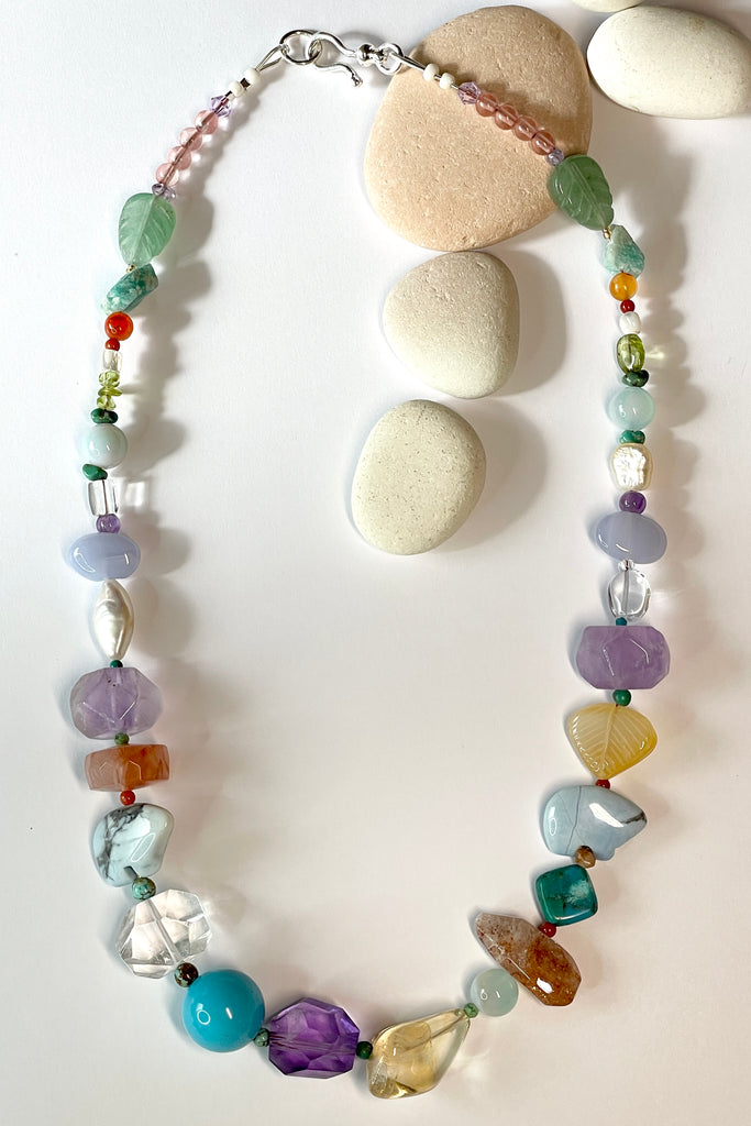 The necklace features two hand carved Zuni bears bought in Tucson Arizona. Stones are Natural Turquoise, Pearl, Amethyst, Carnelian, Clear Rock Crystal Blue Lace Agate,. Citrine, Mother of Pearl shell, Strawberry Quartz and Peridot. 