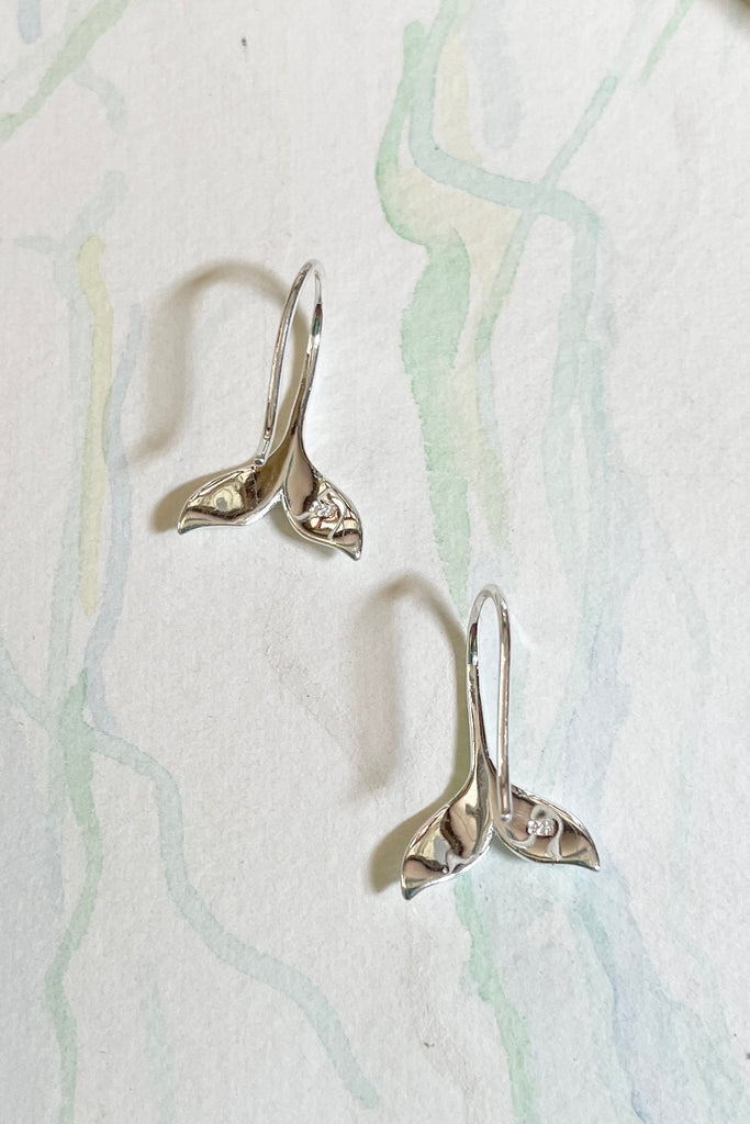 Silver earring whale tail.