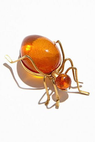 Features the form of a six legged bug with the head and body set with cabochons of natural Baltic honey amber. Marked on underside. A super quirky insect brooch