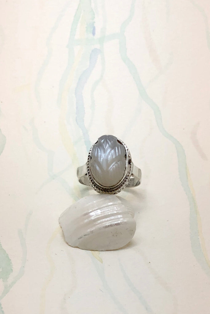 The Echo Ring Moonstone Carving is a handmade moonstone cabachon ring featuring set in silver with a hand carved leaf design.