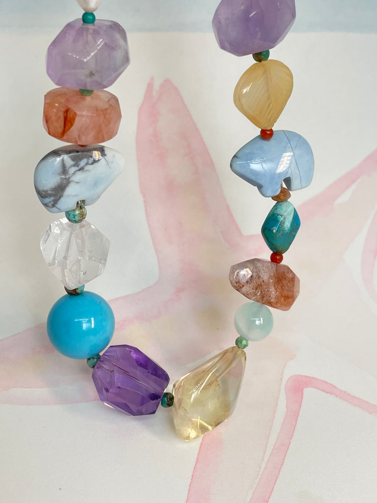The necklace features two hand carved Zuni bears bought in Tucson Arizona. Stones are Natural Turquoise, Pearl, Amethyst, Carnelian, Clear Rock Crystal Blue Lace Agate,. Citrine, Mother of Pearl shell, Strawberry Quartz and Peridot. 