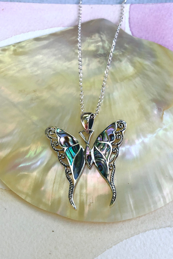 A gorgeous retro style butterfly necklace in shiny silver, with inlaid exotic rainbow Paua shell.