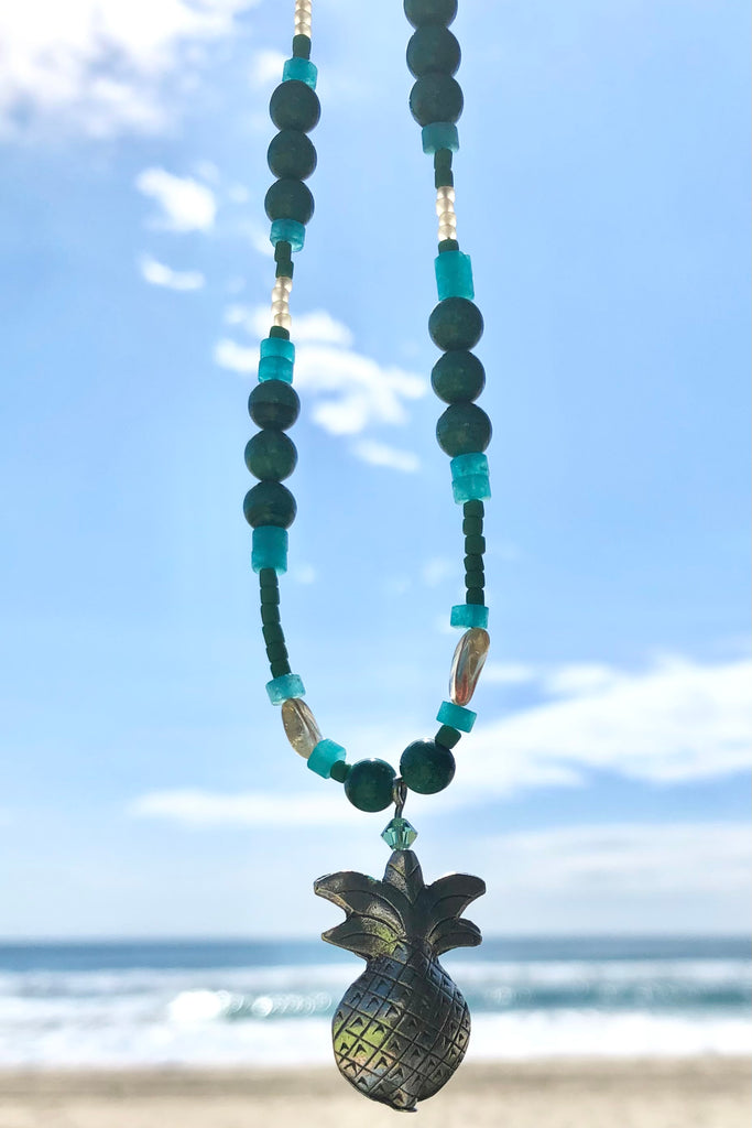 This necklace Sunny Coast inspired one off piece was made in our Noosa Studio,  There is a Thai silver pineapple as the central focus, the beads are the green, gold and turquoise of the area.