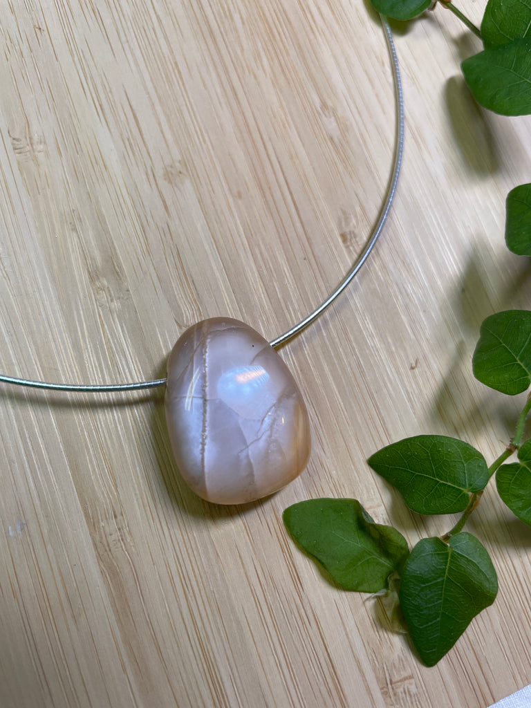 The Pendant is a really lovely luminescent peach moonstone, it hangs from a 925 silver Omega chain. 