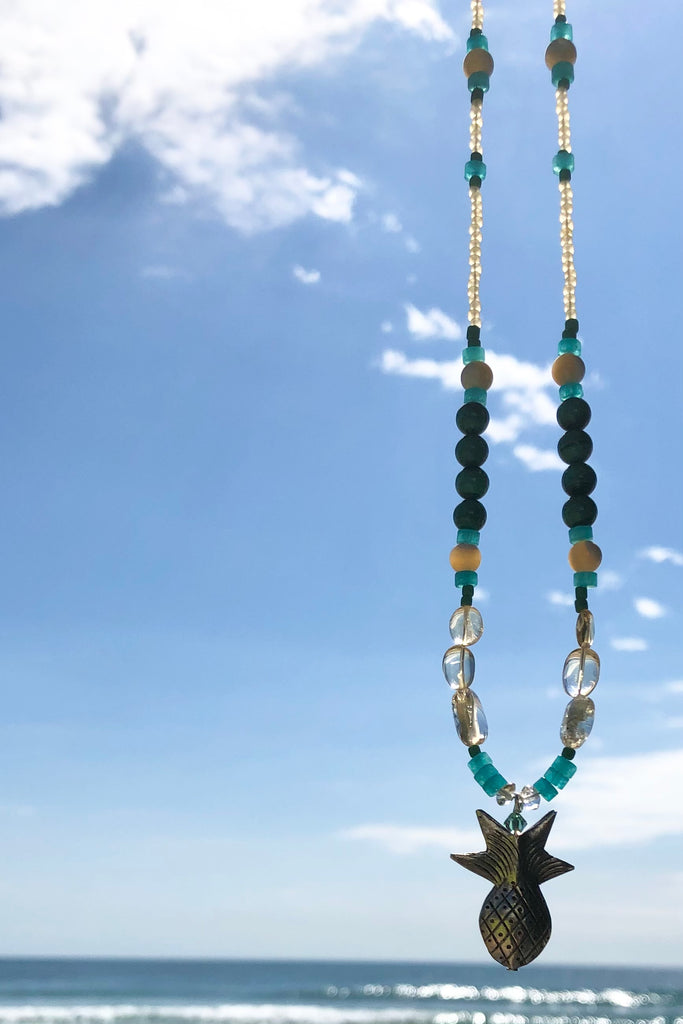 This necklace Sunny Coast inspired one off piece was made in our Noosa Studio,  There is a Thai silver pineapple as the central focus, the beads are the green, gold and turquoise of the area.