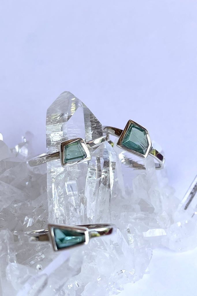 This pale blue green natural tourmaline has been cut in an elegant free form geometric style, then set to fit its unique lines and brilliant colours creating a one of a kind piece. 