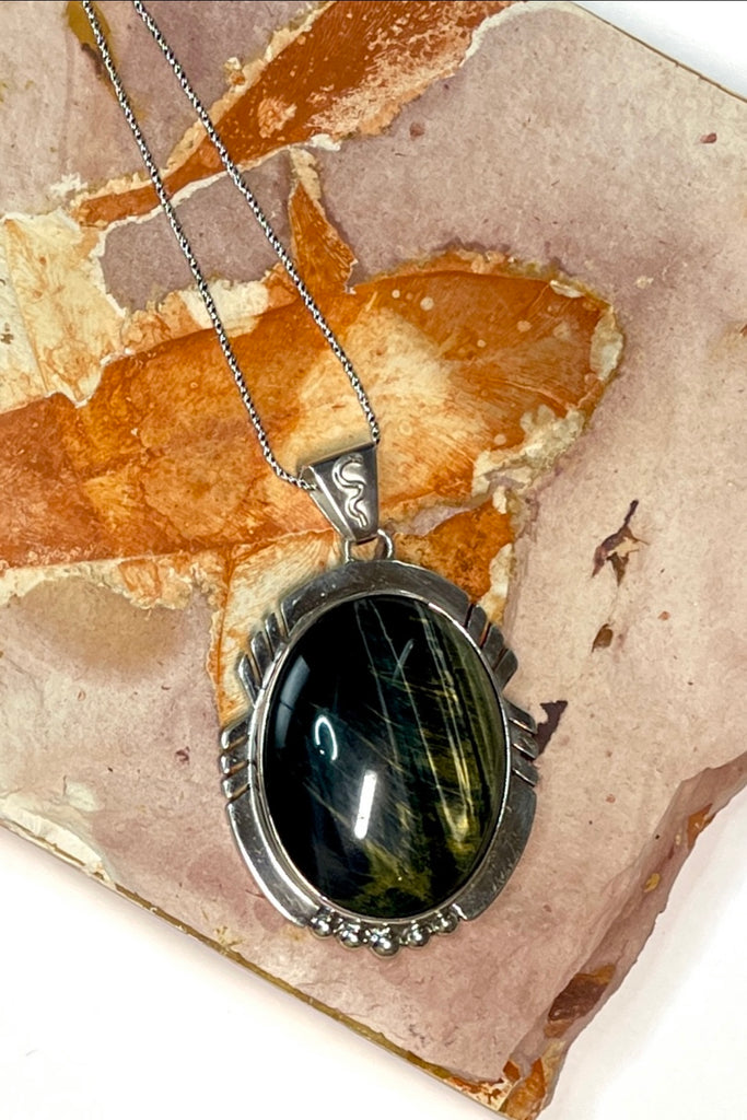 An intriguing powerful and reflecting stone pendant. A modernist pendant in a unique design, the blue Labradorite stone was cut and faceted by a local Sunshine Coast stone artist,