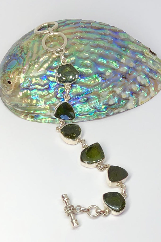 Echo Bracelet Tourmaline Green, each of the six stones  has been individually set and rim set into 925 silver.  The stones are all cut and polished into different shapes and linked in 925 silver.
