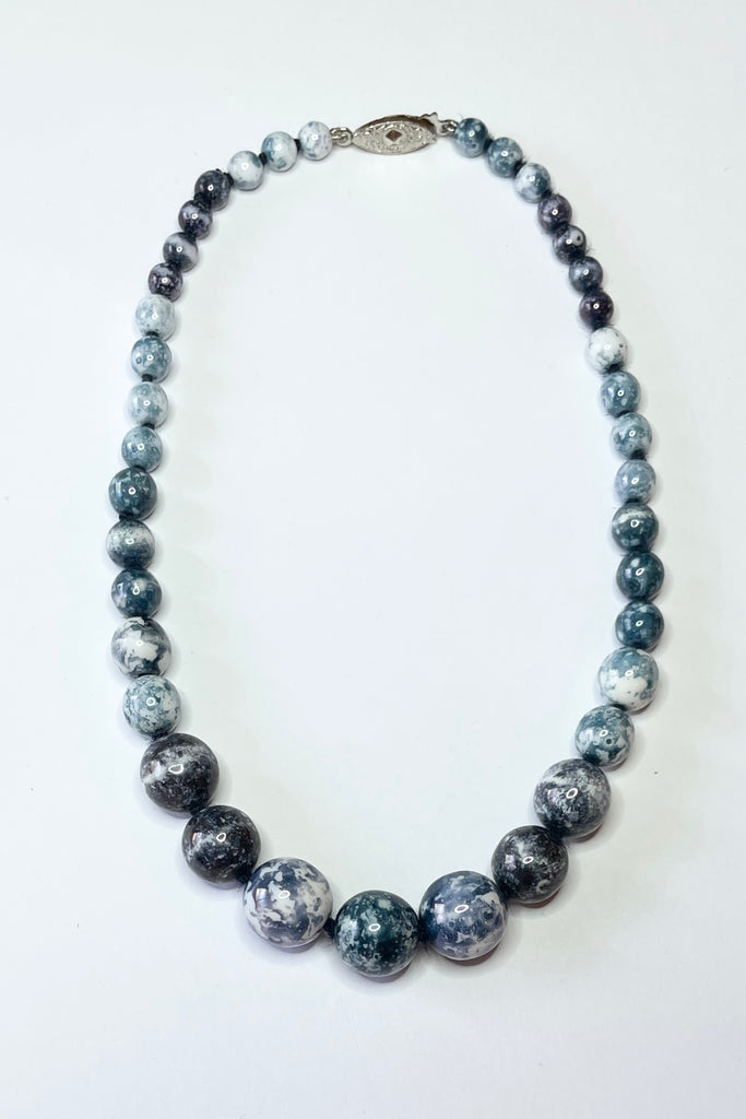 This unusual retro necklace is made with graduated white beads that have a blue grey marbled effect applied. Still on the original knotted cord, the condition is very good.