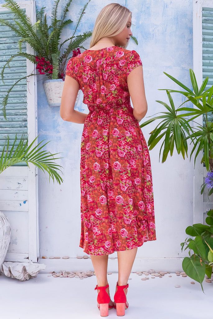 The Lizzie Rose Manor Midi Dress is a gorgeous hot pink based dress with an exclusively designed bohemian tile and overlapping rose print. The dress features cap sleeves, a deep v neckline, fitted Basque waist with gathered bust, elastic shirring at back waist, side pockets and is made from woven 100% rayon.
