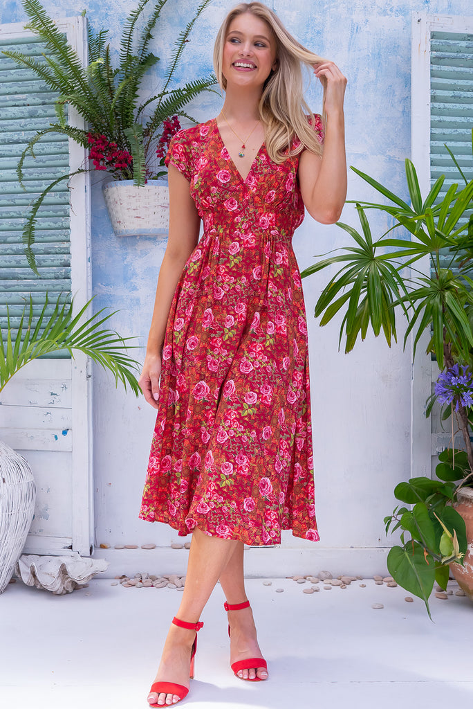 The Lizzie Rose Manor Midi Dress is a gorgeous hot pink based dress with an exclusively designed bohemian tile and overlapping rose print. The dress features cap sleeves, a deep v neckline, fitted Basque waist with gathered bust, elastic shirring at back waist, side pockets and is made from woven 100% rayon.