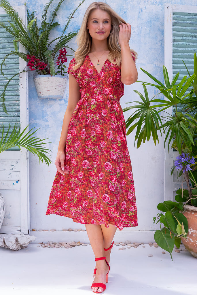 The Lizzie Rose Manor Midi Dress is a gorgeous hot pink based dress with an exclusively designed bohemian tile and overlapping rose print. The dress features cap sleeves, a deep v neckline, fitted Basque waist with gathered bust, elastic shirring at back waist, side pockets and is made from woven 100% rayon.