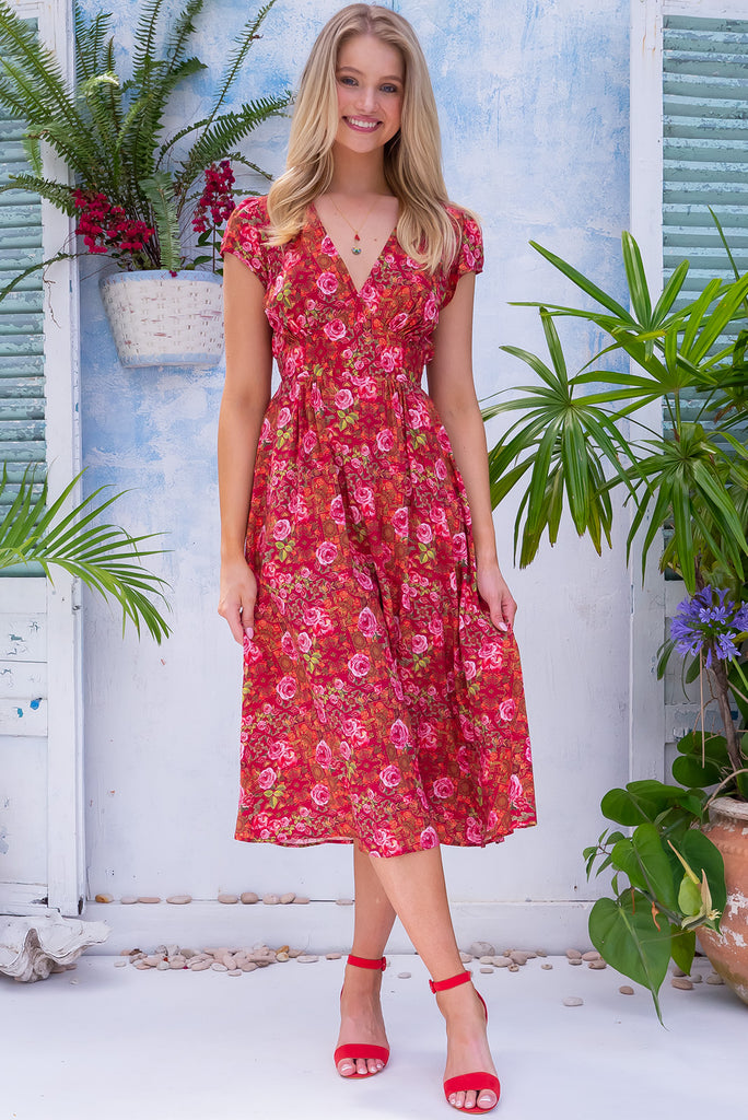 The Lizzie Rose Manor Midi Dress is a gorgeous hot pink based dress with an exclusively designed bohemian tile and overlapping rose print. The dress features cap sleeves, a deep v neckline, fitted Basque waist with gathered bust, elastic shirring at back waist, side pockets and is made from woven 100% rayon.