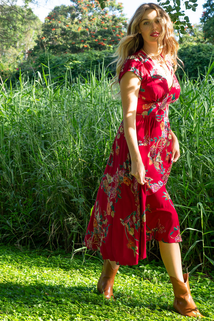 Lizzie Red Bouquet Midi dress features a vintage inspired fitted basque waist and elasticated waist with a cap sleeve and deep v neck the fabric is a soft woven rayon in a bright red bouquet floral print.