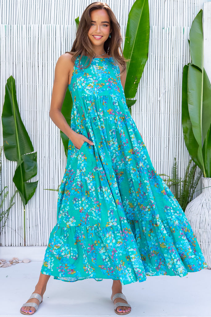 The Lulu Darling Blue Bubble Maxi Dress is a beautiful blue wash effect based dress with a multicoloured bubble print. The maxi dress features a high neck with thin straps, high cut under arms, full tiered skirting from the bust down and deep side pockets. Made from a cotton / rayon woven blend.