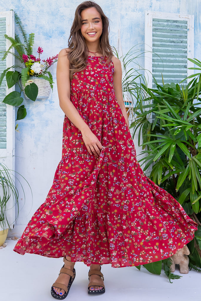 The Lulu Darling Red Spritz Maxi Dress is a beautiful deep red based dress with a floral print. The maxi dress features a high neck with thin straps, high cut under arms, full tiered skirting from the bust down and deep side pockets. Made from a cotton / rayon woven blend.