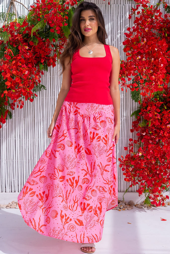 The Sails Cerise Sea Shells Maxi Skirt is a beautiful pink maxi skirt with a Red Sea shell print that is exclusive to Mombasa Rose. The maxi skirt features a v-shaped panelled waistband, elasticated back of was it, curved hemline, slightly longer back and side pockets. Made from woven 100% cotton. Skirt has small white spots due to the texture of the fabric.
