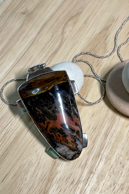 A powerful and intriguing Morrocan Jasper pendant reflecting the story of the ancient rock. A modernist setting in a unique design,