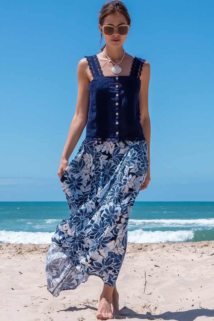 The Positano Navy Lace Cami Top is a beautiful navy coloured textured cami top with lace detailing on the straps, front and hem. The shirt also features a functional shell button front.