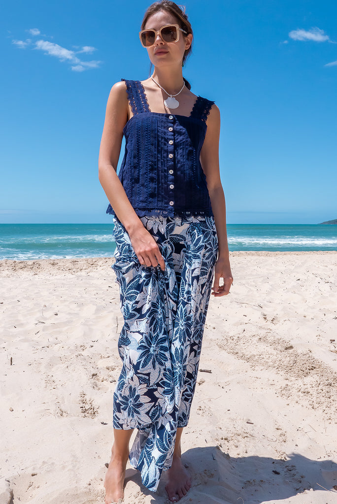 The Positano Navy Lace Cami Top is a beautiful navy coloured textured cami top with lace detailing on the straps, front and hem. The shirt also features a functional shell button front.