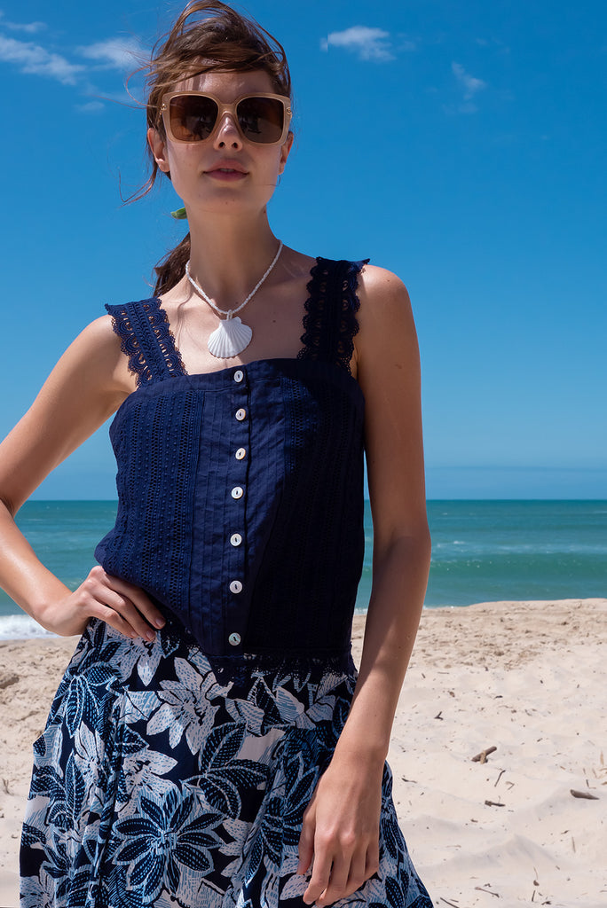 The Positano Navy Lace Cami Top is a beautiful navy coloured textured cami top with lace detailing on the straps, front and hem. The shirt also features a functional shell button front.