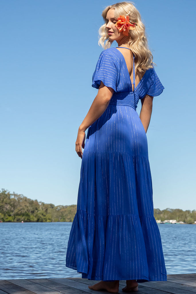 The striking Romance Aphrodite Blue Maxi Dress gives a subtle nod to glamorous past eras with its glittering pinstripe and elegant silhouette – perfect for dinner dates and evening events. Whether you're on the beachfront or rooftop, this dress is sure to impress. 100% crinkle viscose.